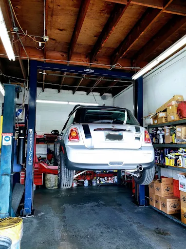 A car raised on the two-post lift inside the Manila Brakes & Auto Repair Inc. service bay