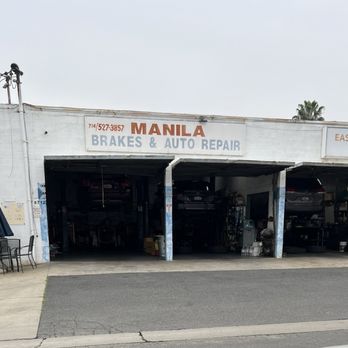 The Manila Brakes & Auto Repair Inc. building on Stanton Ave, with the phone number painted beside the hand-lettered sign and two open bays
